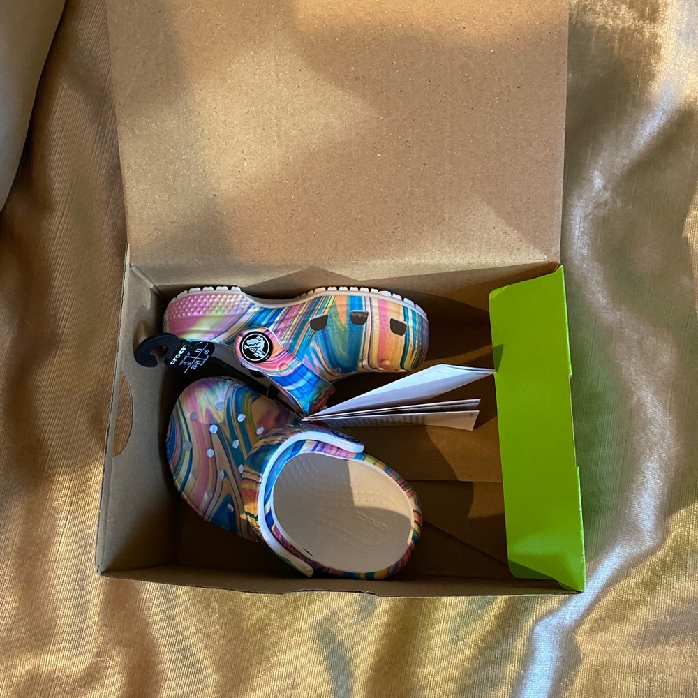 Brand new little girl crocs with patterns. Size 5